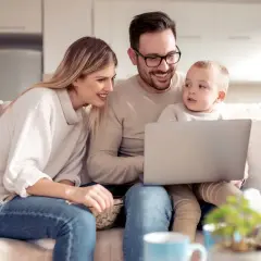 Rodzina ogląda coś na laptopie. Zastanawiają się, czy świadczenie socjalne wlicza się do dochodu, planując przyszłość.