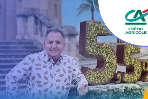 Mężczyzna obok czekoladowych cyfr 5,5% i logo Crédit Agricole. Odkryj atrakcyjne lokaty w Crédit Agricole!