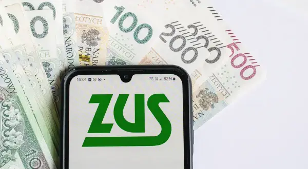 Telefon z logo ZUS na tle polskich banknotów. Czy to zapowiedź 13 emerytury 2026? Tabela z wypłatami wkrótce.